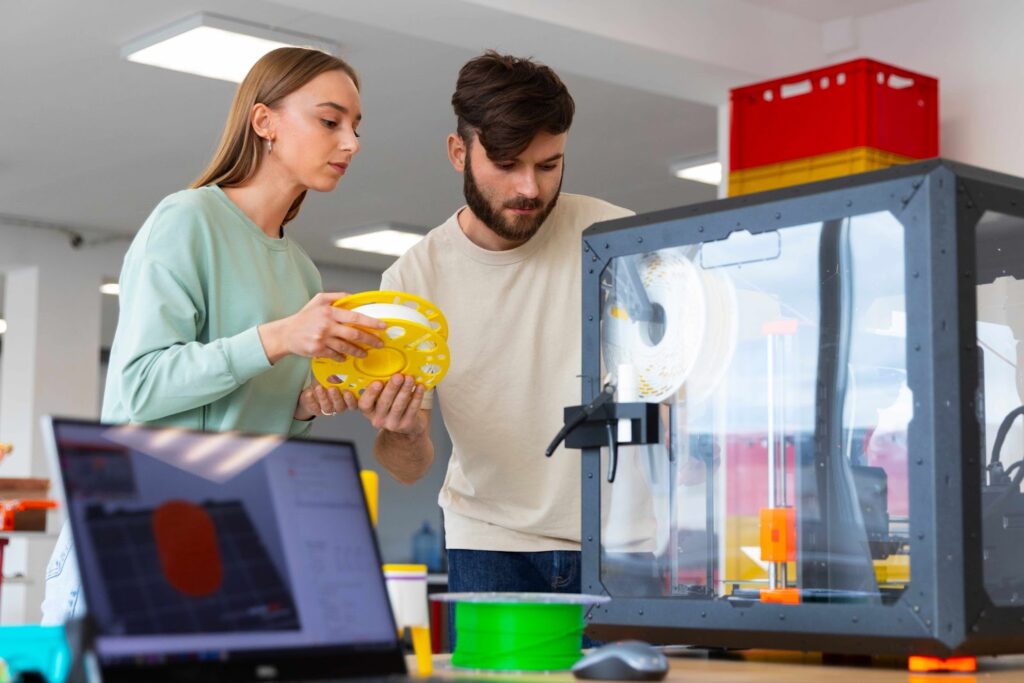 Woman and man using a 3d printer